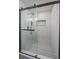 Contemporary shower with glass door, white tiled walls, and rainfall showerhead at 1360 S Forest Way, Denver, CO 80222