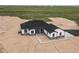 Aerial view of modern home with expansive acreage and desert landscape at 62101 E 32Nd Ct, Strasburg, CO 80136