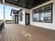 This spacious back porch features an elegant dark wood deck, white trim, and lovely views at 62101 E 32Nd Ct, Strasburg, CO 80136
