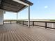 Enjoy the views from this elegant porch with dark wood flooring and white columns at 62101 E 32Nd Ct, Strasburg, CO 80136