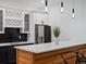 This bar area includes custom cabinets, pendant lights, barstool seating, and stainless steel appliances at 62101 E 32Nd Ct, Strasburg, CO 80136