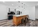 Enjoy this bar area featuring custom cabinets, a wood bar, pendant lighting, and barstool seating at 62101 E 32Nd Ct, Strasburg, CO 80136