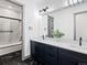 Stylish bathroom with black and white marble tile, modern fixtures, and a large vanity at 62101 E 32Nd Ct, Strasburg, CO 80136