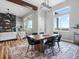 Bright dining area with large windows, modern lighting, and stylish furniture on decorative rug at 62101 E 32Nd Ct, Strasburg, CO 80136