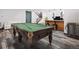Spacious game room with billiard table, wet bar, and cozy seating is ready for fun at 62101 E 32Nd Ct, Strasburg, CO 80136