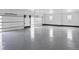 Large garage with a polished concrete floor and multiple windows for natural light at 62101 E 32Nd Ct, Strasburg, CO 80136