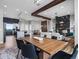 Open-concept living and dining area featuring modern decor, wood floors, and a cozy fireplace at 62101 E 32Nd Ct, Strasburg, CO 80136