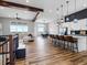 Spacious open-concept living area with hardwood floors, modern lighting and large windows at 62101 E 32Nd Ct, Strasburg, CO 80136