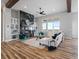 Cozy living room with a stone fireplace, built-in shelves, and comfortable seating at 62101 E 32Nd Ct, Strasburg, CO 80136