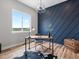 Cozy office space with a modern desk, stylish decor, and ample natural light from a large window at 62101 E 32Nd Ct, Strasburg, CO 80136