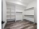 Spacious walk-in closet with built-in shelving and hanging rods for organization at 62101 E 32Nd Ct, Strasburg, CO 80136