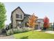 Inviting two-story home with stone details, well-kept lawn, and colorful autumn foliage at 6938 E Lake Dr, Centennial, CO 80111