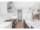 This kitchen is equipped with stainless steel appliances, white subway tile backsplash and white cabinets and countertops at 6938 E Lake Dr, Centennial, CO 80111