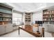 Spacious home office featuring built-in bookshelves, a window seat, and a large desk for remote working at 6938 E Lake Dr, Centennial, CO 80111