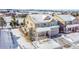 Two-story house with snow covered yard, two-car garage, and neighborhood view at 2229 Candleglow St, Castle Rock, CO 80109