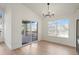 Bright dining room featuring hardwood floors, modern chandelier and sliding glass doors to a spacious outdoor deck at 9640 Silver Hill Cir, Lone Tree, CO 80124