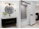 Basement bathroom with a black vanity, round mirror, and tub shower at 3360 Broadway St, Boulder, CO 80304