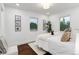 Well-lit bedroom with a queen bed, hardwood floors, and artwork at 3360 Broadway St, Boulder, CO 80304