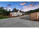 Newly renovated home with a large driveway and a wood fence at 3360 Broadway St, Boulder, CO 80304