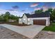 White brick home with a dark brown garage door and landscaping at 3360 Broadway St, Boulder, CO 80304