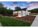 White brick home with landscaped yard, large driveway and a detached garage at 3360 Broadway St, Boulder, CO 80304