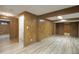 Finished basement room with wood paneling and an adjacent bathroom at 13739 E Marina Dr # B, Aurora, CO 80014