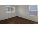 Simple bedroom with two windows and wood flooring at 13739 E Marina Dr # B, Aurora, CO 80014