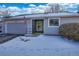 Gray siding townhouse exterior with snowy front yard and American flag at 13739 E Marina Dr # B, Aurora, CO 80014