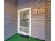 Front door entrance with security door and light fixture at 13739 E Marina Dr # B, Aurora, CO 80014