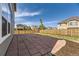 Backyard features a large stone patio, fence and grass at 1488 N Stratton Ave, Castle Rock, CO 80104