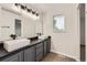 Contemporary bathroom with dual vessel sinks, dark gray cabinets, and modern lighting fixtures at 1488 N Stratton Ave, Castle Rock, CO 80104