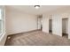 Comfortable bedroom with carpet, sliding door closet, and a view of an open doorway at 1488 N Stratton Ave, Castle Rock, CO 80104