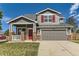 Beautiful two-story home with a brick-accented facade, a well-manicured lawn, and a welcoming front porch at 1488 N Stratton Ave, Castle Rock, CO 80104