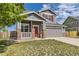 Lovely two-story home featuring a gray exterior, a front porch, and a well-kept lawn in a Gathering-friendly neighborhood at 1488 N Stratton Ave, Castle Rock, CO 80104