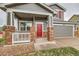 Welcoming front porch with brick pillars, white railings, and a vibrant red front door, enhancing curb appeal at 1488 N Stratton Ave, Castle Rock, CO 80104