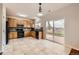 Bright kitchen with wooden cabinets, black appliances, tile flooring, and sliding door to patio at 1488 N Stratton Ave, Castle Rock, CO 80104