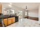 Spacious kitchen featuring wood cabinets, tile backsplash, black appliances, and a sliding glass door to the backyard at 1488 N Stratton Ave, Castle Rock, CO 80104