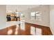 Bright living room with hardwood floors connects to kitchen, has a sliding door and a view out the window at 1488 N Stratton Ave, Castle Rock, CO 80104