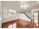 Bright living room with gleaming hardwood floors, large window, staircase, and modern light fixture at 1488 N Stratton Ave, Castle Rock, CO 80104