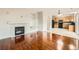 Open-concept living room with hardwood floors, fireplace, built-ins, leading to the kitchen at 1488 N Stratton Ave, Castle Rock, CO 80104