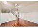 Bright living room featuring gleaming hardwood floors, a staircase, and neutral paint, offering a blank canvas at 1488 N Stratton Ave, Castle Rock, CO 80104