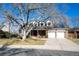 Charming brick home with a two-car garage, mature trees, and solar panels at 8274 S Jackson St, Centennial, CO 80122