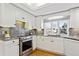 Bright kitchen with white cabinets, granite counters, and stainless steel appliances at 8274 S Jackson St, Centennial, CO 80122