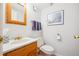 A convenient powder room with a decorative mirror and wooden sink at 8274 S Jackson St, Centennial, CO 80122