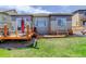 Landscaped backyard with wooden decks, green grass and trees at 18027 Telford Ave, Parker, CO 80134