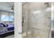 Bathroom with shower, neutral tile, and view to bedroom at 18027 Telford Ave, Parker, CO 80134