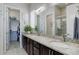 Modern bathroom featuring a double vanity, granite countertops, and a walk-in shower at 18027 Telford Ave, Parker, CO 80134
