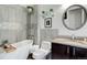 Modern bathroom with gray tiling, a soaking tub, and decorative accents at 18027 Telford Ave, Parker, CO 80134