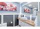 Stylish bathroom with a vessel sink, wood counter, wainscoting and unique decor at 18027 Telford Ave, Parker, CO 80134