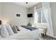 Inviting bedroom featuring a flat screen TV, bench seating, large window, and natural light at 18027 Telford Ave, Parker, CO 80134